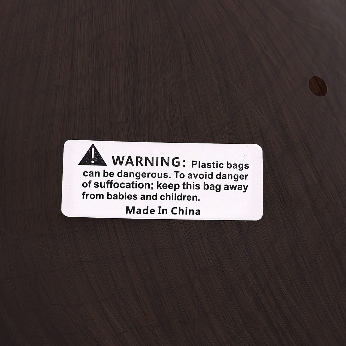 Premium packaging of Joseph Joestar cosplay wig showing protective netting and neatly arranged dark brown fibers