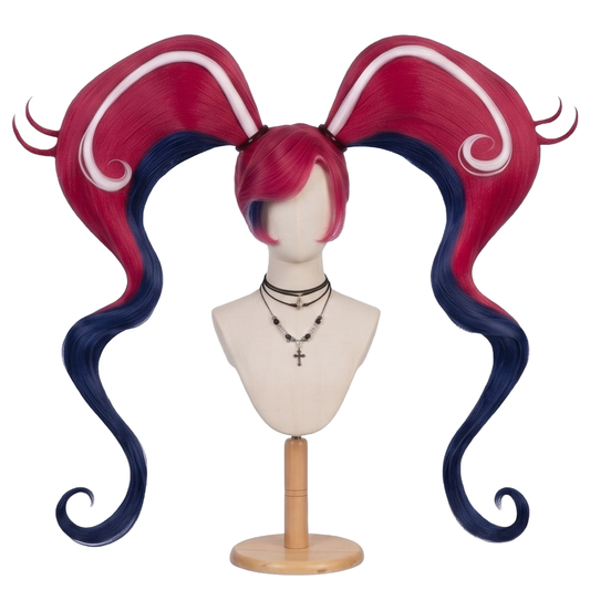 Velvette cosplay wig from Hazbin Hotel featuring desire-red twin pigtails, faded dark navy-blue inner sections, and signature white swirled streaks on the bangs and hair